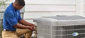 Technician repairing central air conditioner in Toronto, Ontario
