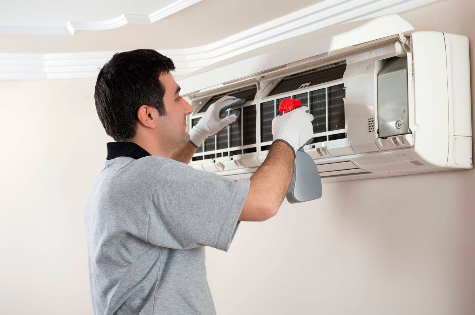 Technician servicing air conditioner in Toronto, ON
